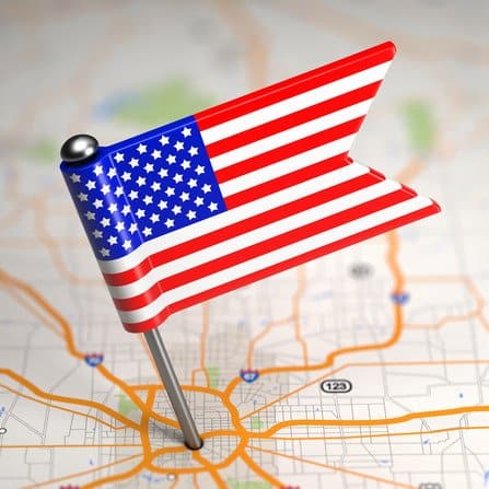 United States of America Small Flag on a Map Background.