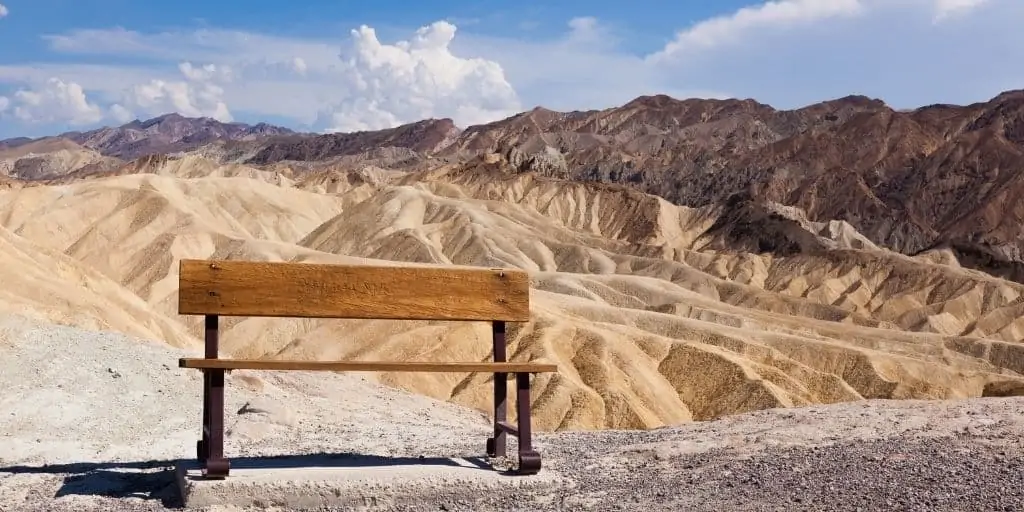 eroded ridges at death valley, bench in foreground