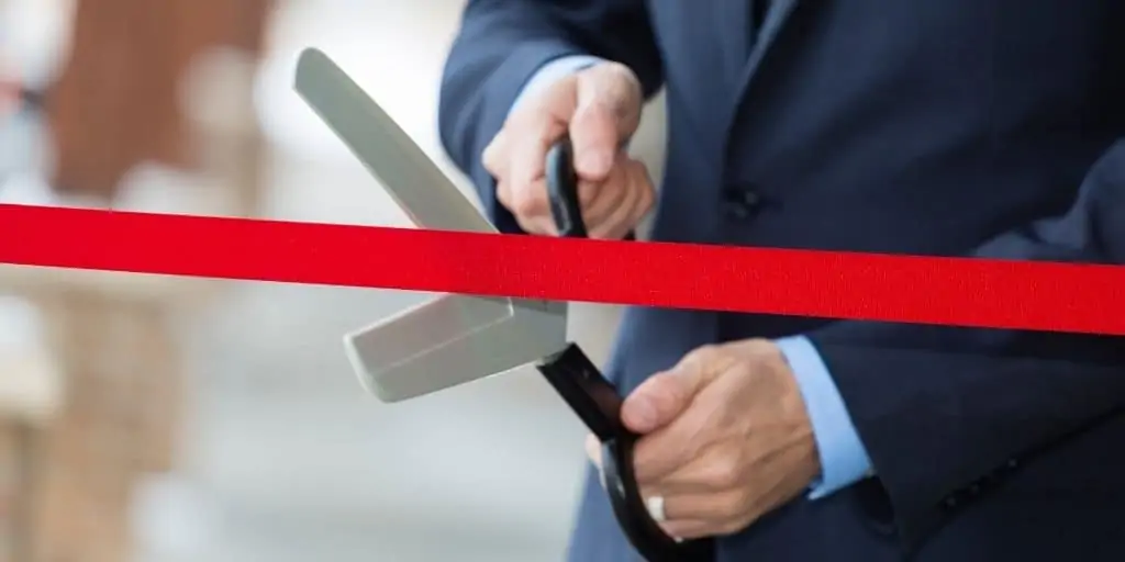 transitioning to full-time real estate investing cutting ribbon